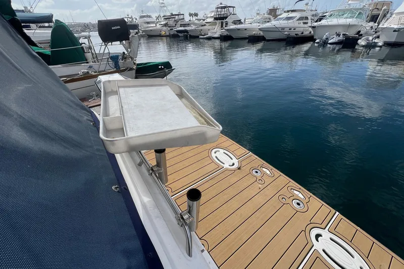Slide: The Image of 2007 Bayliner 305 boat docked in marina with wooden deck and metal tray. - 4