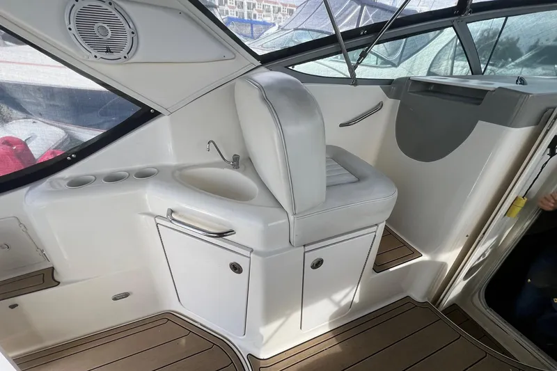 Slide: The Image of 2007 Bayliner 305 boat interior with seating, sink, and storage. - 5
