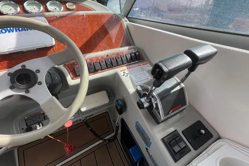 Slide: The Image of 2007 Bayliner 305 boat cockpit with steering wheel, controls, and instrument panel. - 8
