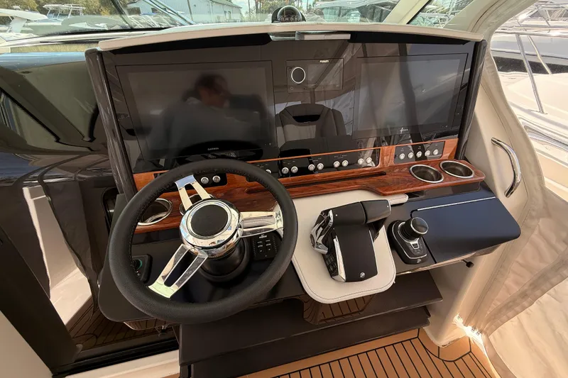Slide: The Image of 2022 Tiara Yachts 38 LS helm with modern controls and dual displays. - 10