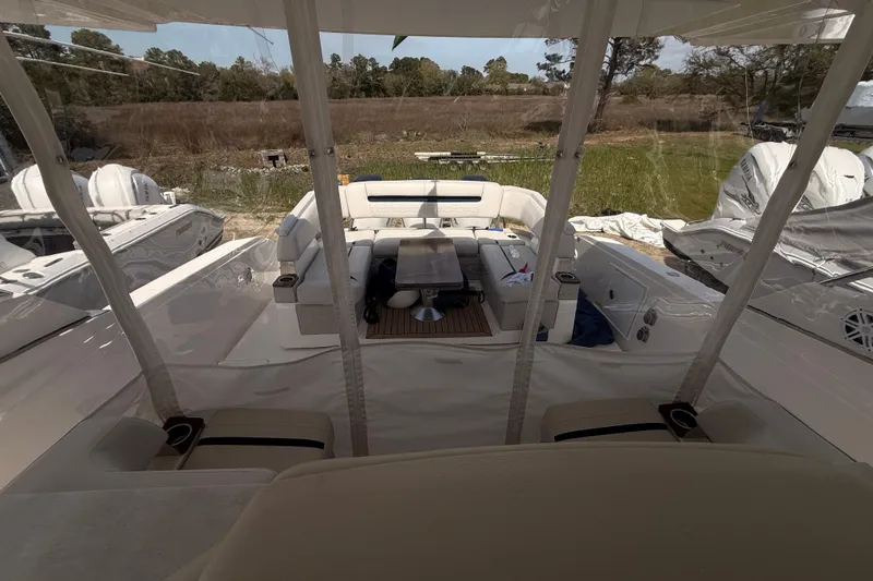 Slide: The Image of 2022 Tiara Yachts 38 LS interior view with seating and outdoor backdrop. - 11