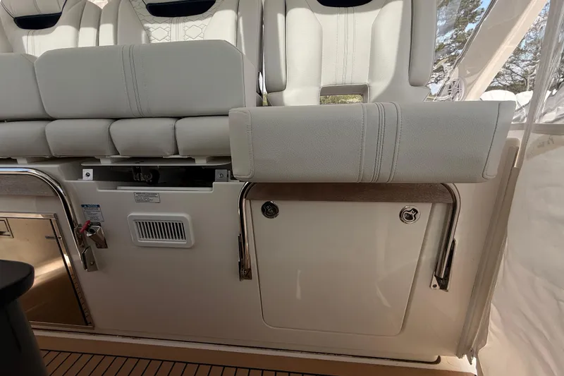 Slide: The Image of 2022 Tiara Yachts 38 LS interior seating with storage compartment and elegant design. - 18
