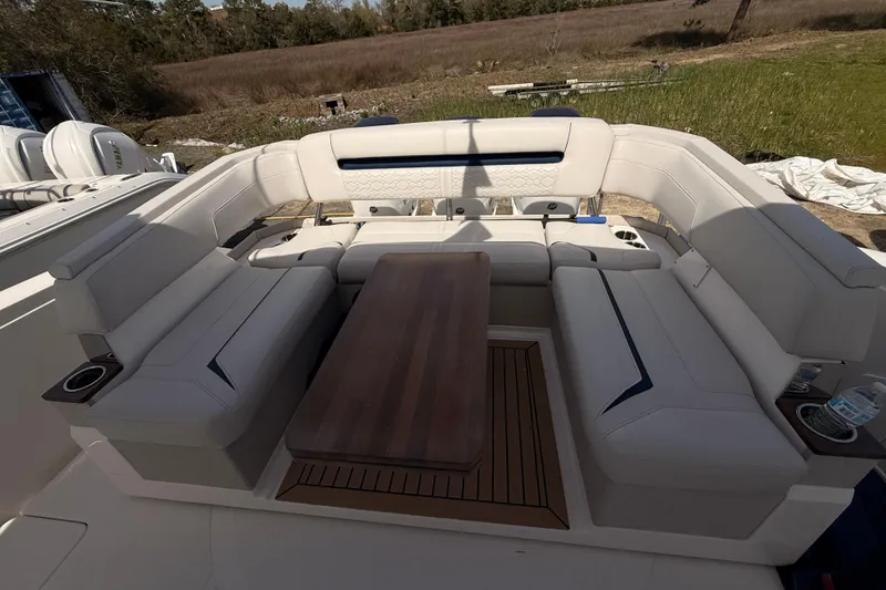 Slide: The Image of Luxurious seating area on 2022 Tiara Yachts 38 LS with elegant wooden table. - 19