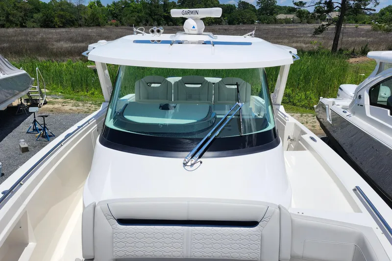Slide: The Image of 2022 Tiara Yachts 38 LS boat with sleek design and spacious deck, docked outdoors. - 34