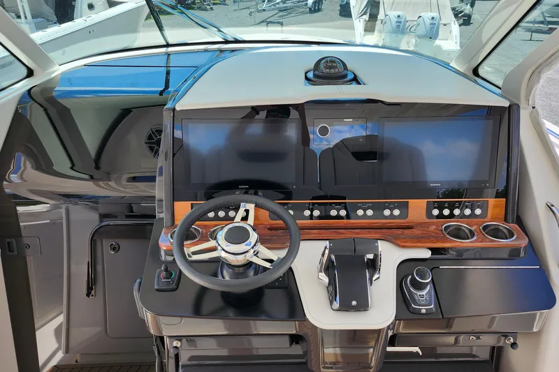 Slide: The Image of Helm of 2022 Tiara Yachts 38 LS featuring modern controls and dual displays. - 37