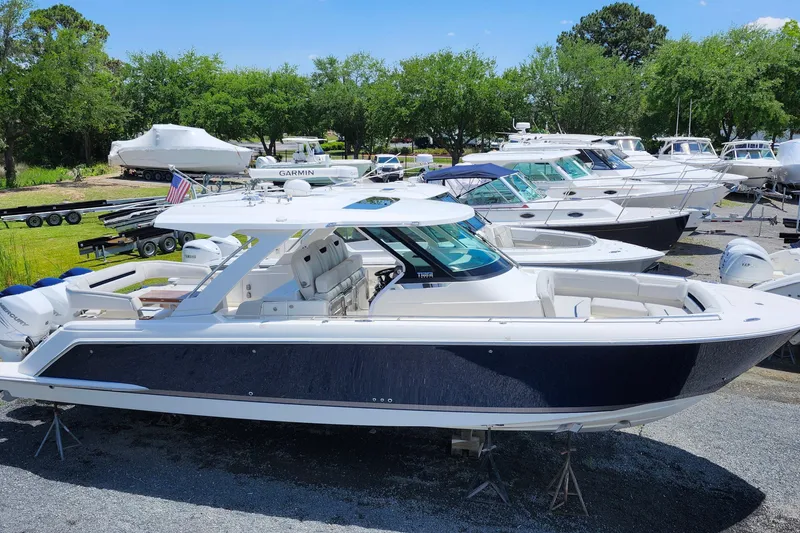 Slide: The Image of 2022 Tiara Yachts 38 LS boat displayed in a marina with other vessels. - 39