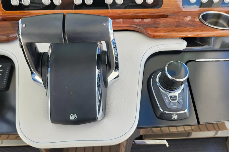 Slide: The Image of Control panel of a 2022 Tiara Yachts 38 LS, featuring throttle and joystick controls. - 43