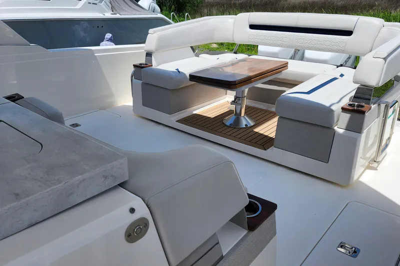 Slide: The Image of 2022 Tiara Yachts 38 LS luxury seating area with elegant table and cushioned seats. - 48