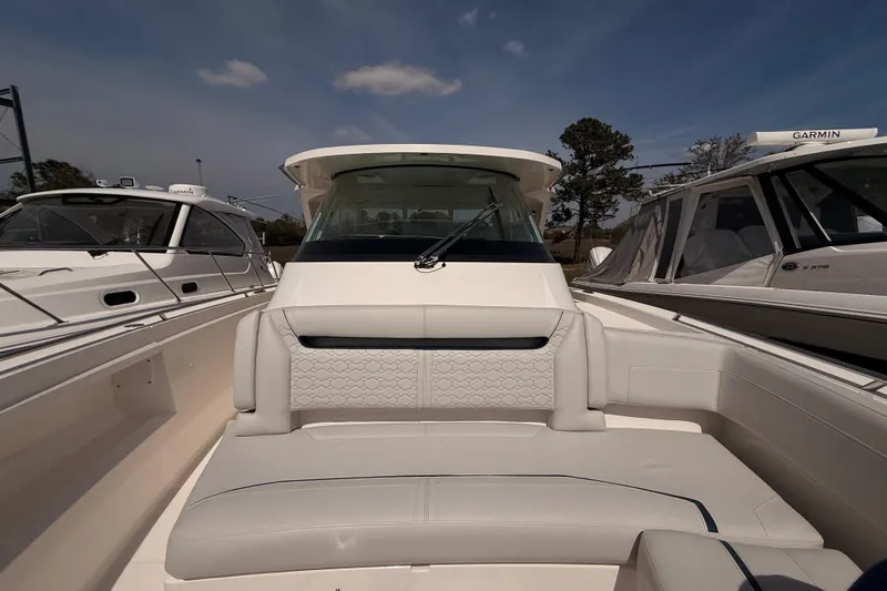 Slide: The Image of 2022 Tiara Yachts 38 LS luxury boat interior with plush seating and modern design. - 5