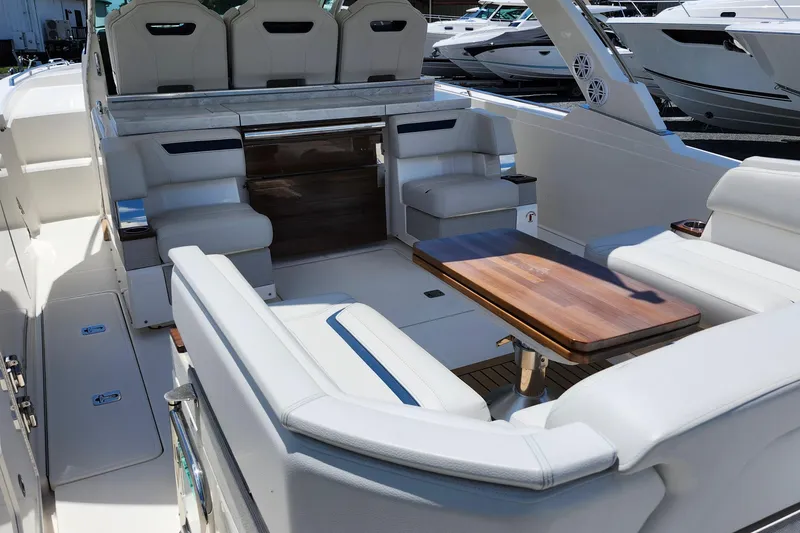 Slide: The Image of Luxurious interior of 2022 Tiara Yachts 38 LS with elegant seating and wooden table. - 54
