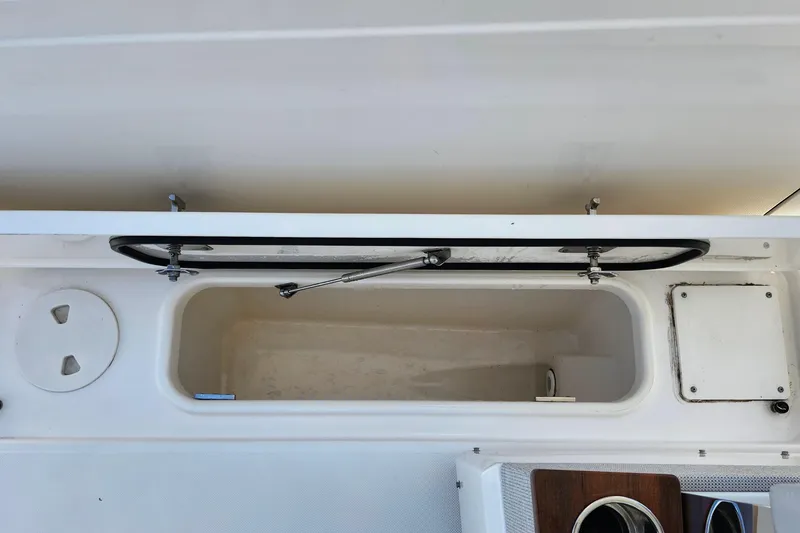 Slide: The Image of Open storage compartment on a 2022 Tiara Yachts 38 LS boat. - 58