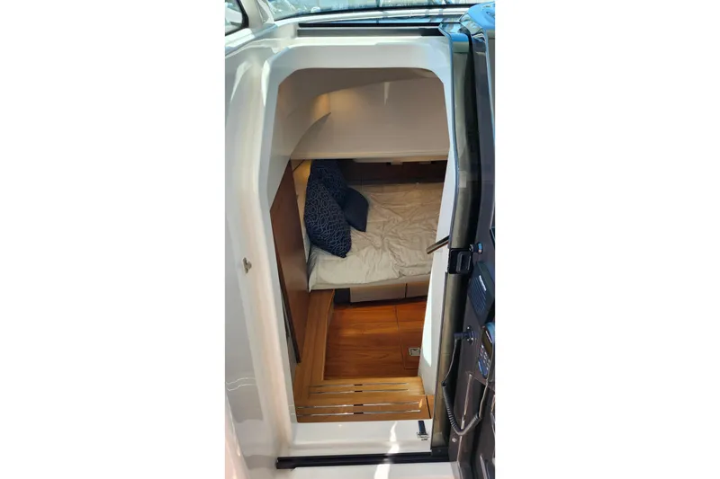 Slide: The Image of Interior cabin view of 2022 Tiara Yachts 38 LS, featuring cozy bedding and wooden flooring. - 62
