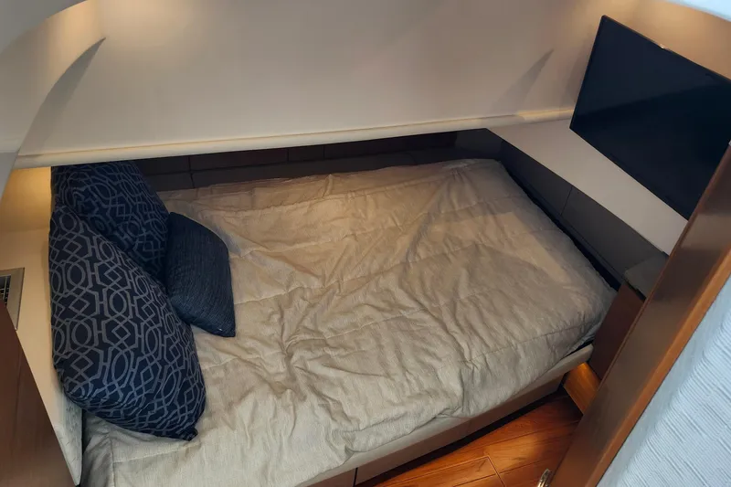 Slide: The Image of Cozy cabin interior of 2022 Tiara Yachts 38 LS with bed and TV. - 63