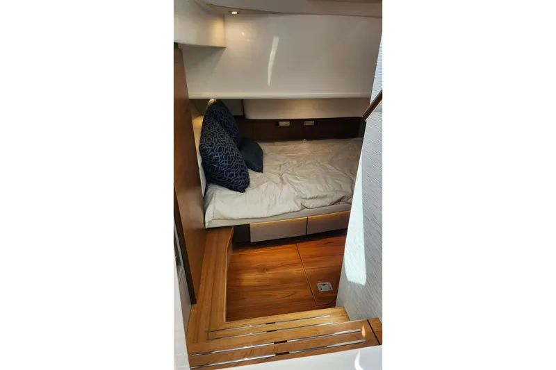 Slide: The Image of 2022 Tiara Yachts 38 LS cabin interior with cozy bed and wooden flooring. - 64