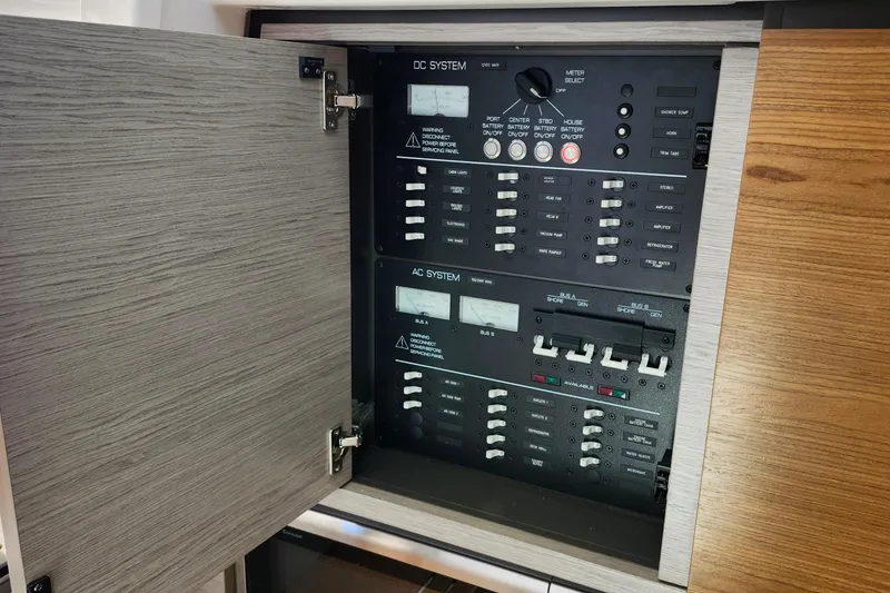 Slide: The Image of Electrical panel of 2022 Tiara Yachts 38 LS, showcasing DC and AC systems. - 65