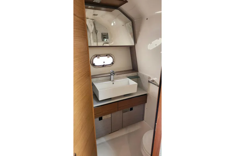 Slide: The Image of Modern bathroom interior of 2022 Tiara Yachts 38 LS, featuring sleek sink and wooden cabinetry. - 70