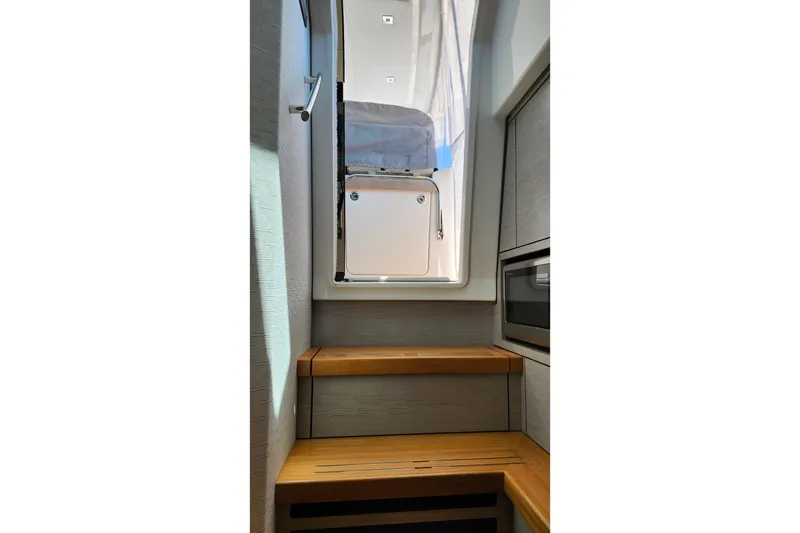 Slide: The Image of Interior view of 2022 Tiara Yachts 38 LS, featuring wooden steps and modern design. - 72