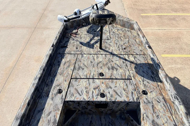 Slide: The Image of 2025 Ranger RB210 boat with camo design, featuring a trolling motor and spacious deck. - 10