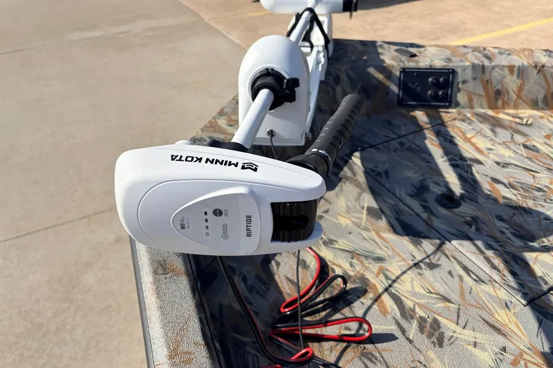Slide: The Image of 2025 Ranger RB210 boat with Minn Kota Riptide trolling motor on camo-patterned deck. - 12