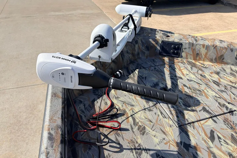 Slide: The Image of Ranger RB210 2025 boat with Minn Kota trolling motor on camo-patterned deck. - 13