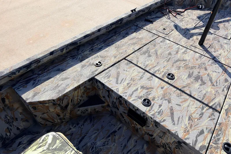 Slide: The Image of 2025 Ranger RB210 boat interior with camo pattern and storage compartments. - 15