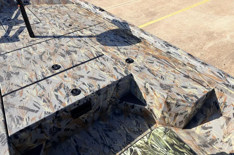 Slide: The Image of 2025 Ranger RB210 boat deck with camouflage pattern and storage compartments. - 17