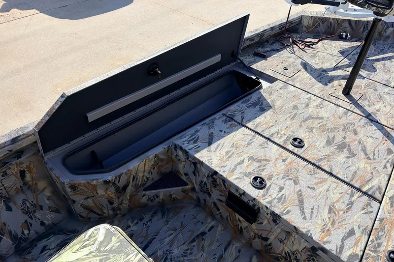 Slide: The Image of 2025 Ranger RB210 boat interior with open storage compartment, showcasing camo design. - 18