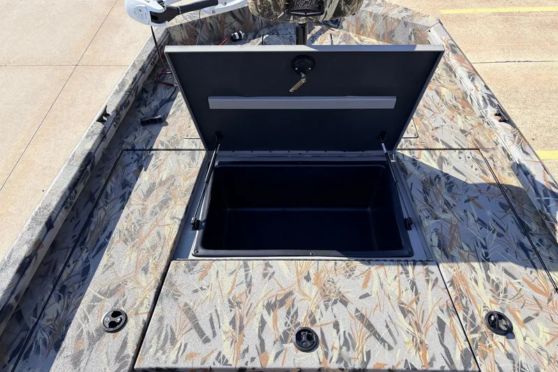 Slide: The Image of Open storage compartment on 2025 Ranger RB210 boat with camouflage pattern. - 20