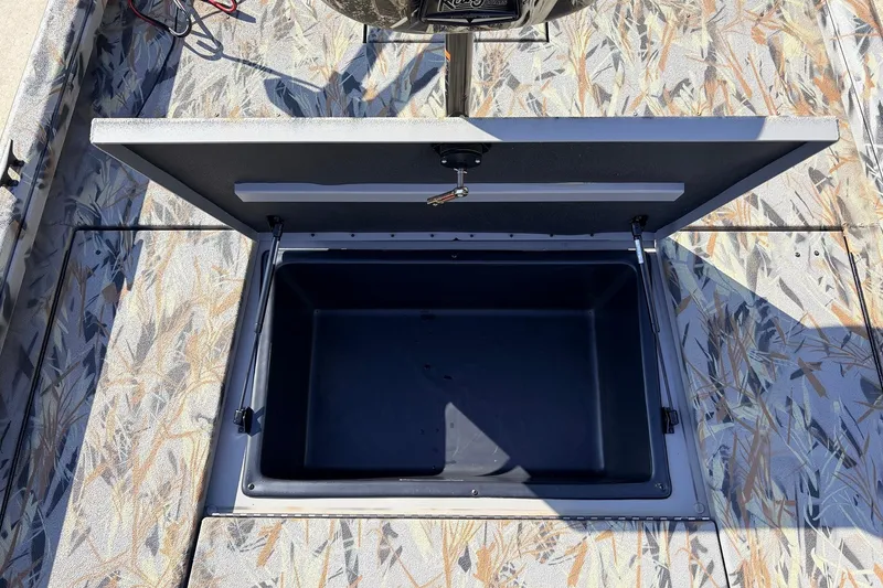 Slide: The Image of 2025 Ranger RB210 boat storage compartment with open lid, showcasing interior space. - 21