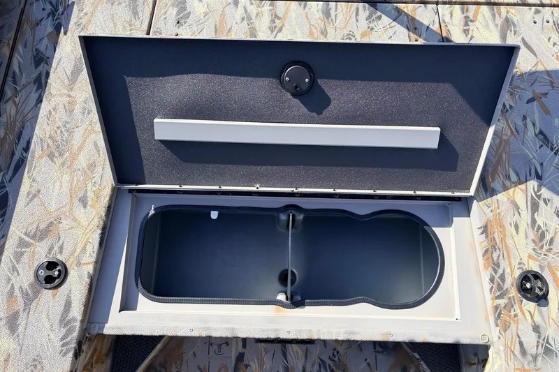 Slide: The Image of Open storage compartment on 2025 Ranger RB210 boat with camouflage pattern. - 23