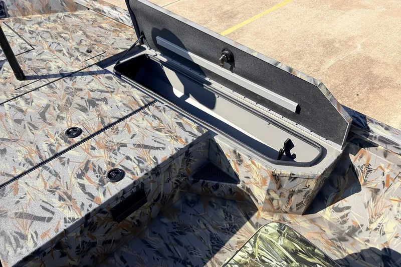 Slide: The Image of 2025 Ranger RB210 boat with open storage compartment, featuring a camouflage pattern. - 24