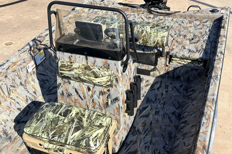 Slide: The Image of 2025 Ranger RB210 boat interior with camouflage design and steering console. - 32