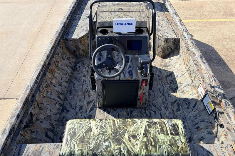 Slide: The Image of 2025 Ranger RB210 boat interior with camouflage design and Lowrance navigation system. - 33