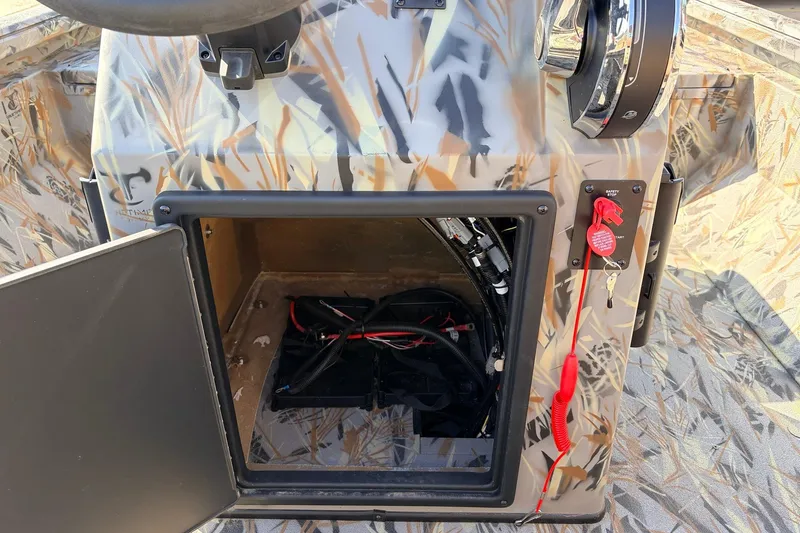 Slide: The Image of 2025 Ranger RB210 boat console with open storage compartment and camouflage design. - 38