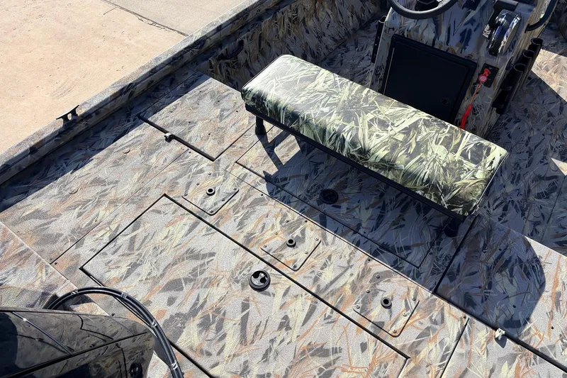 Slide: The Image of 2025 Ranger RB210 boat interior with camouflage design and bench seat. - 41