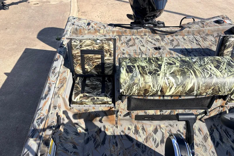 Slide: The Image of 2025 Ranger RB210 boat with camouflage seating and deck, featuring a mounted motor. - 42