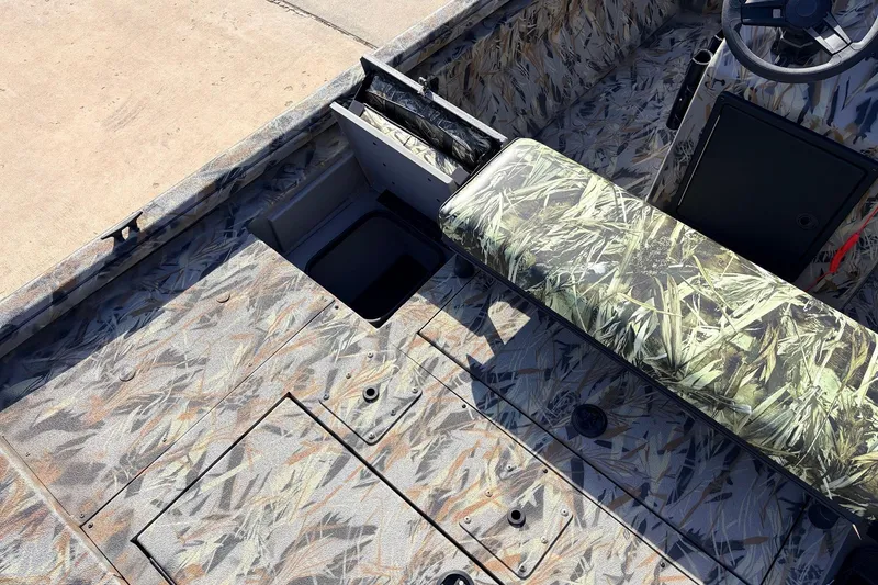 Slide: The Image of 2025 Ranger RB210 boat interior with camouflage seating and storage compartments. - 45