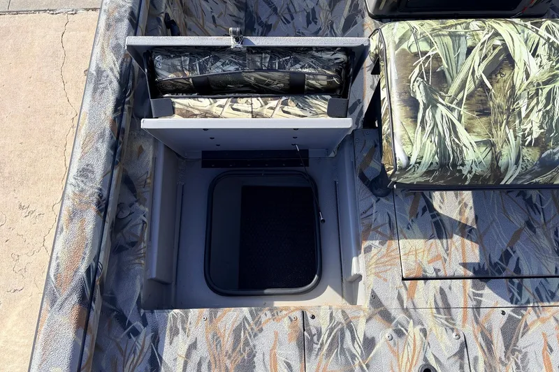 Slide: The Image of 2025 Ranger RB210 boat interior with camo seating and storage compartment. - 46
