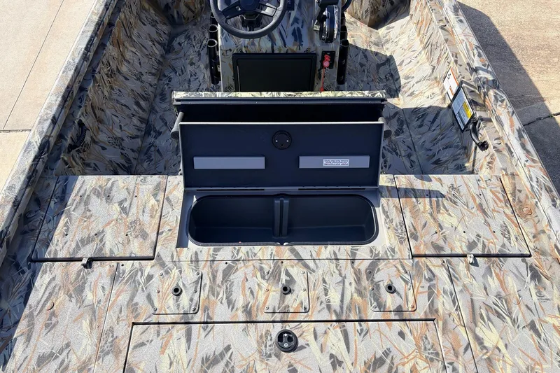 Slide: The Image of 2025 Ranger RB210 boat interior with camo design and open storage compartment. - 49