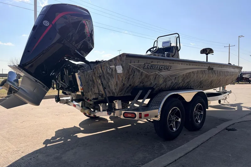 Slide: The Image of 2025 Ranger RB210 boat on trailer with powerful outboard motor, parked outdoors. - 5