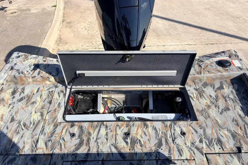 Slide: The Image of Open storage compartment on 2025 Ranger RB210 boat with camouflage pattern. - 51