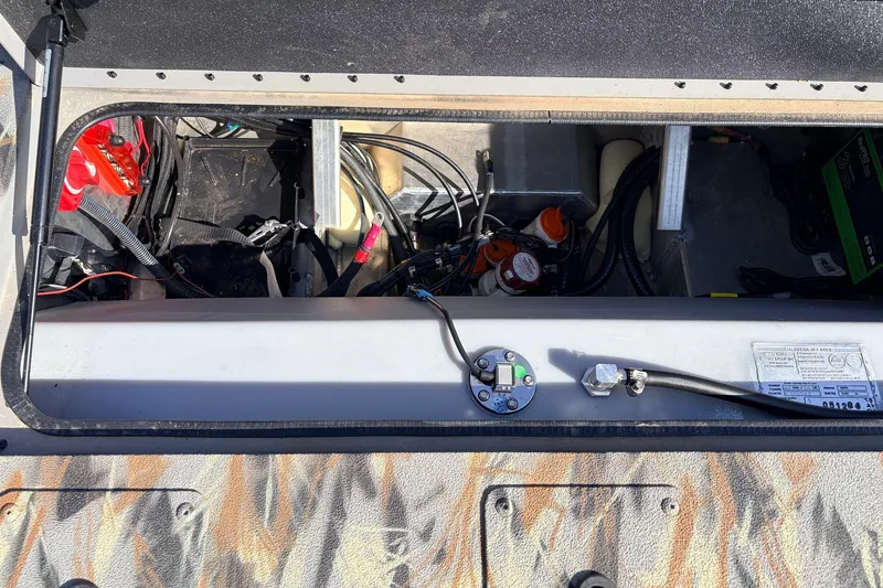 Slide: The Image of Open compartment of 2025 Ranger RB210 boat showing wiring and components. - 52