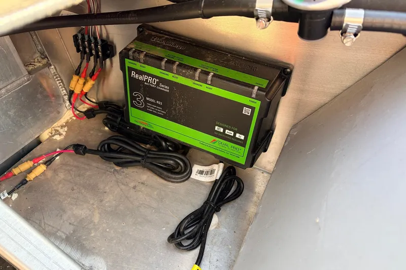 Slide: The Image of Battery charger in a 2025 Ranger RB210 boat, featuring RealPRO Series Model RS3. - 53