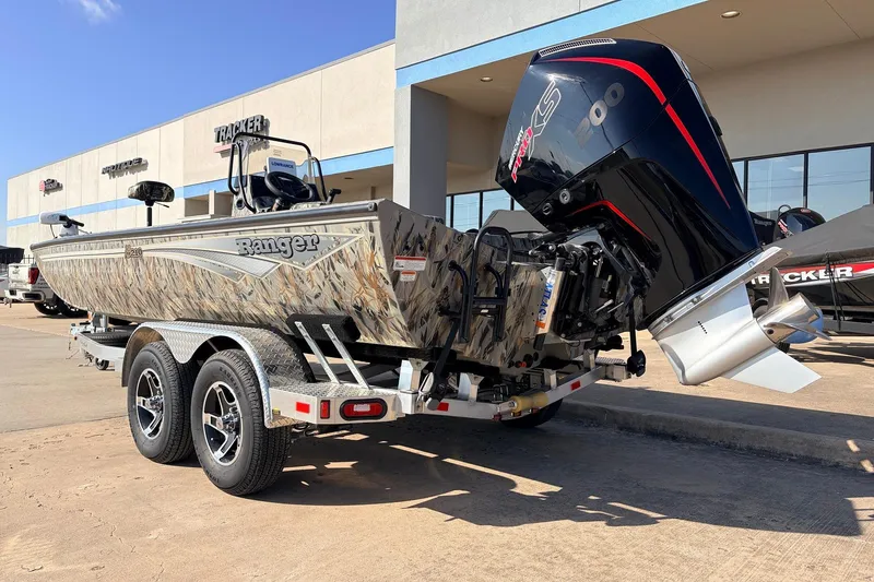 Slide: The Image of 2025 Ranger RB210 boat with camo design and powerful outboard motor on trailer. - 7