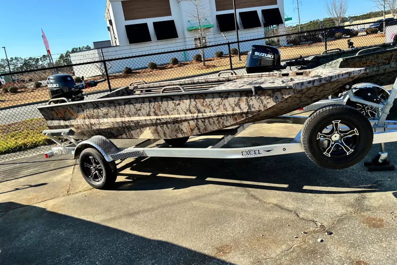 Slide: The Image of 2023 Excel 1754 Shallow Water F4 boat on trailer, camo design, Suzuki motor. - 14