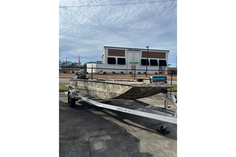 Slide: The Image of 2023 Excel 1754 Shallow Water F4 boat on trailer, parked outdoors. - 20