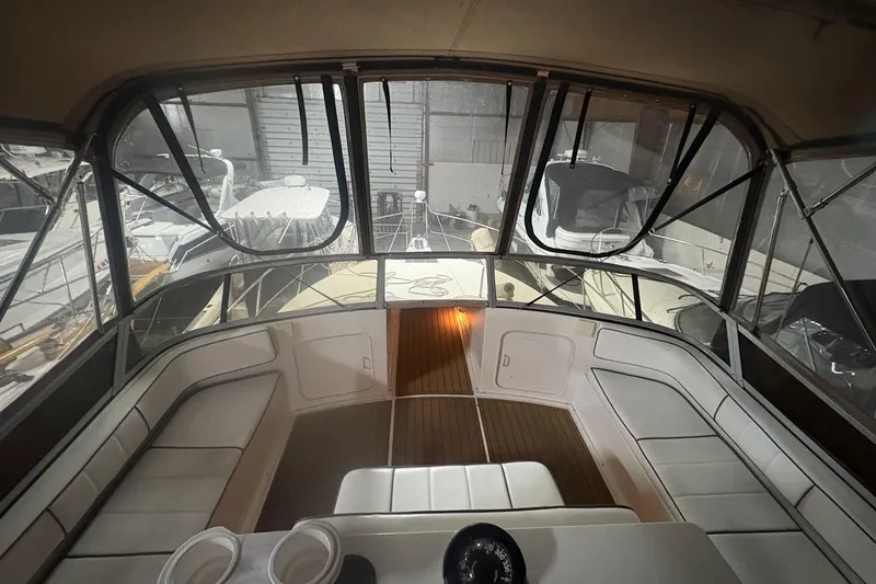 The Image of 1996 Carver 38 Santego yacht cruising on open blue sea under clear sky. - 0