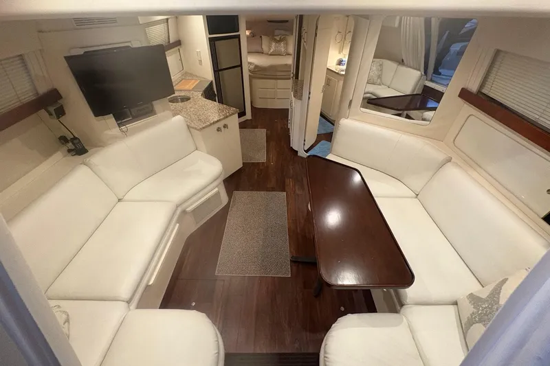 Slide: The Image of 1996 Carver 38 Santego yacht interior with stairs and docked boats in background. - 13