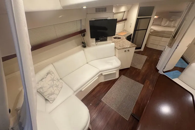 Slide: The Image of 1996 Carver 38 Santego yacht docked indoors, surrounded by other boats. - 14