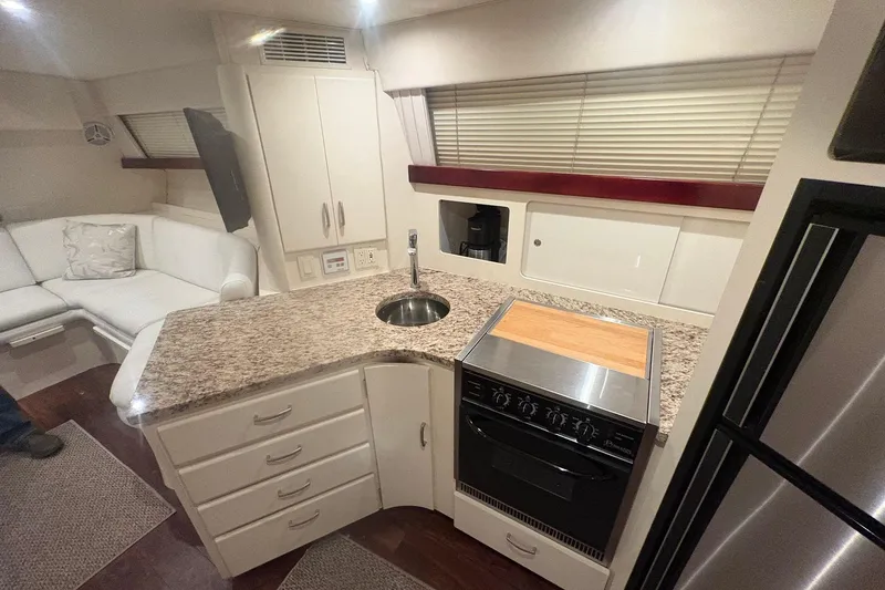 Slide: The Image of Interior of 1996 Carver 38 Santego yacht with white seating and modern amenities. - 17